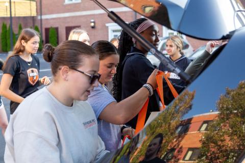 Female students helping new students move in