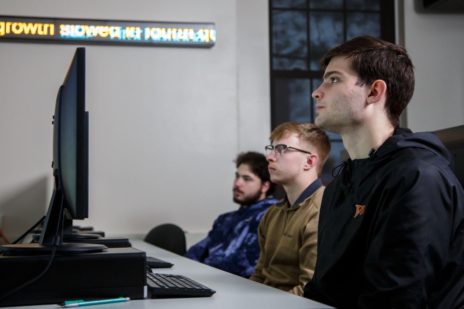 Waynesburg students sit in the stock exchange classroom in Business Administration