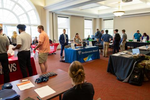 Employer representatives and students at the Business and Communication Fair