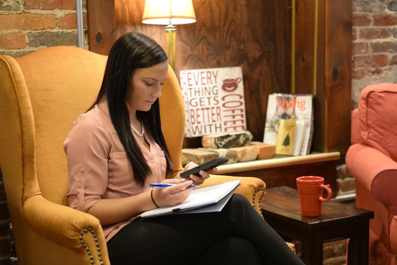 female looking at book