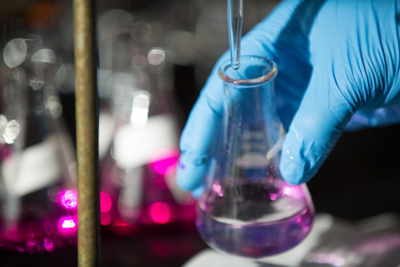 Chemist filling a beaker