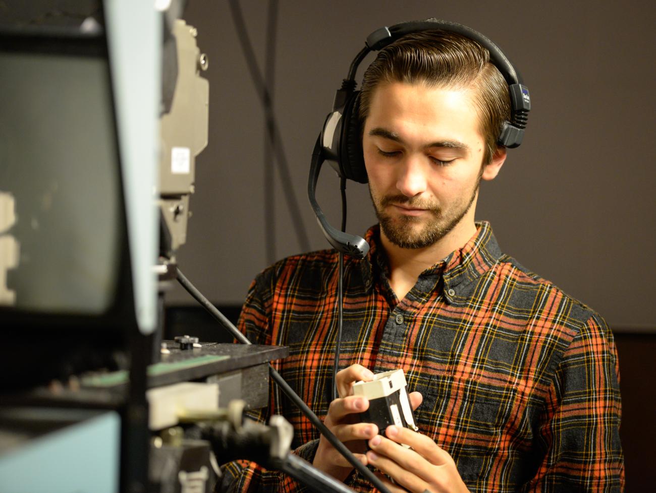 Student uses audio visual equipment