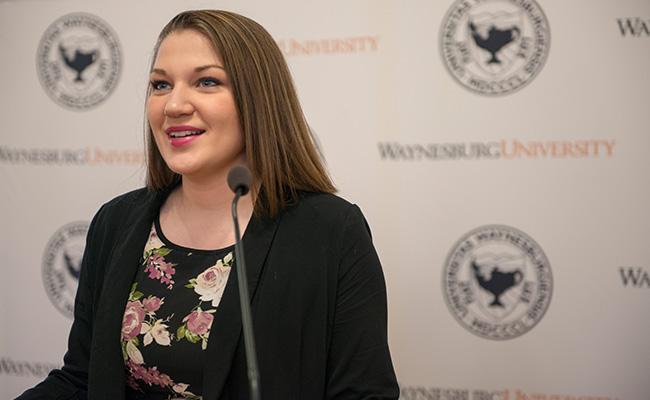 Maura Fenske announces President Lee at a press conference