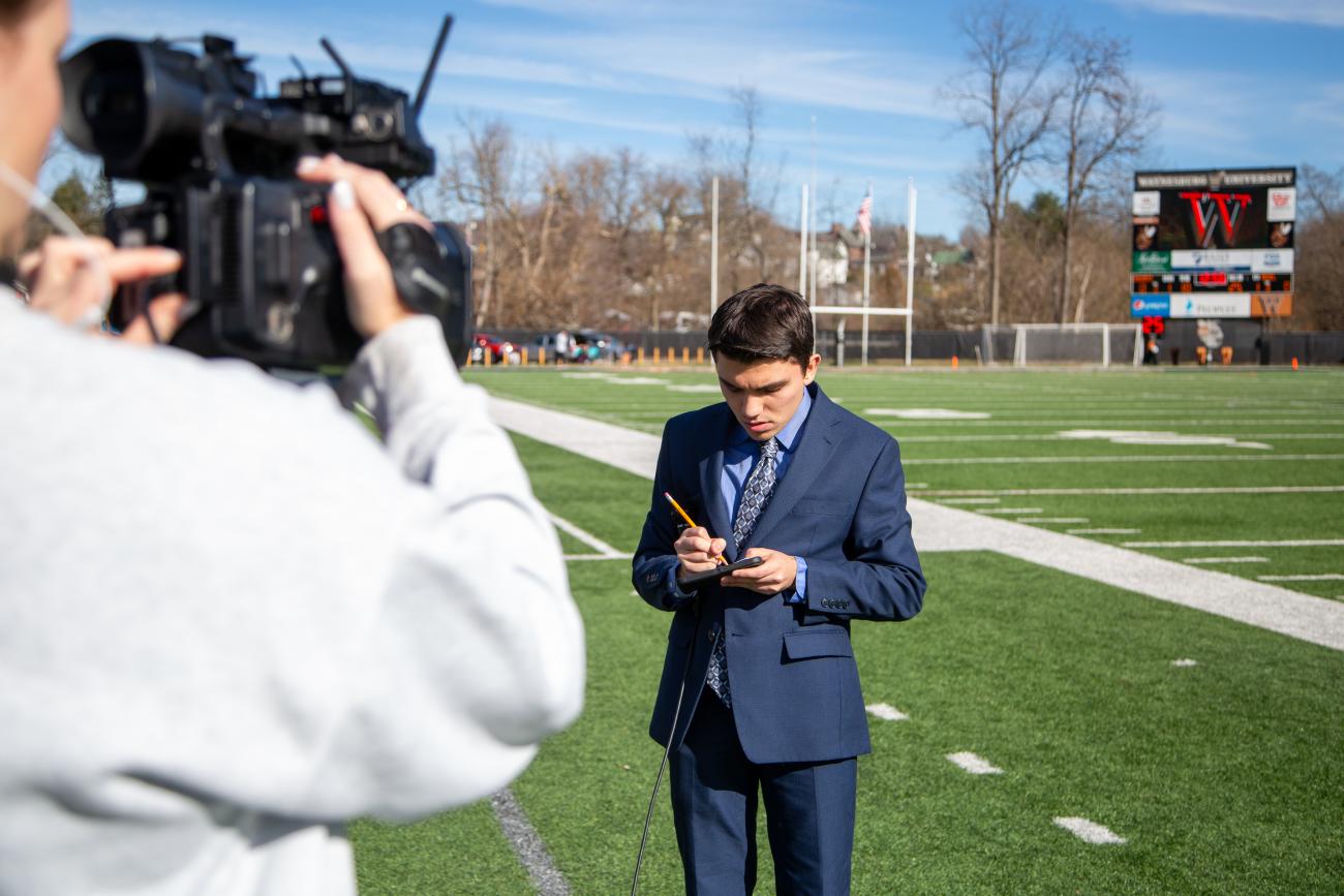 Waynesburg Communication student on football field during senior day