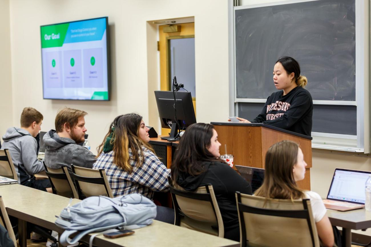 Student presents in business class on campus