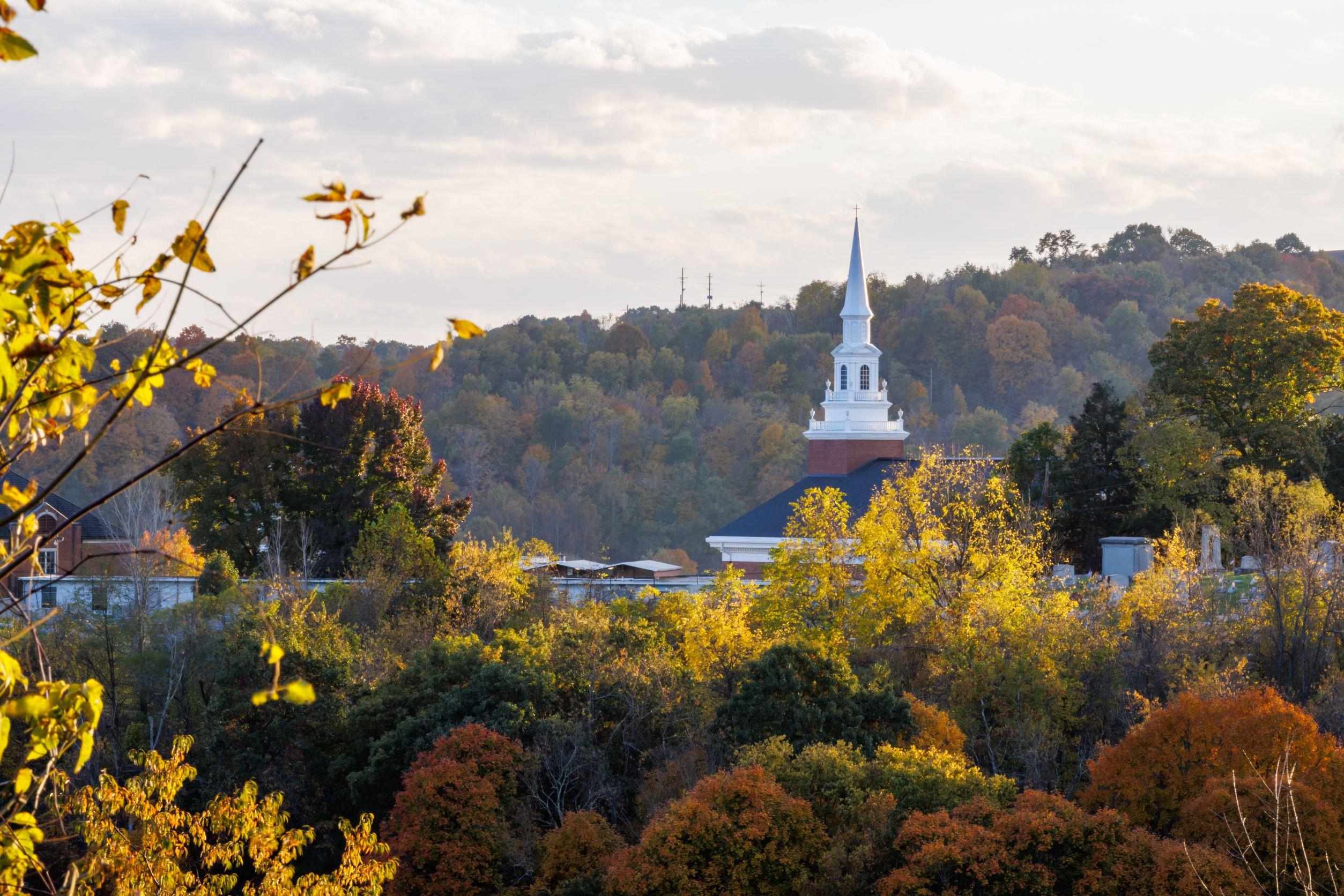 Image of Roberts Chapel surrounded by trees in Autumn