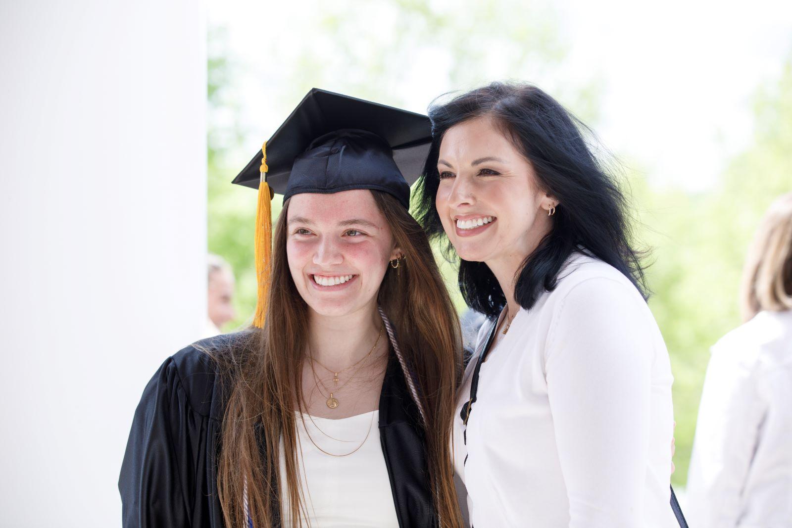 A graduate poses with parent