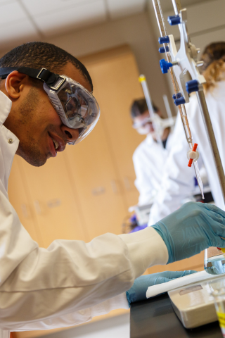 Chemistry student working in the chemistry lab with beakers