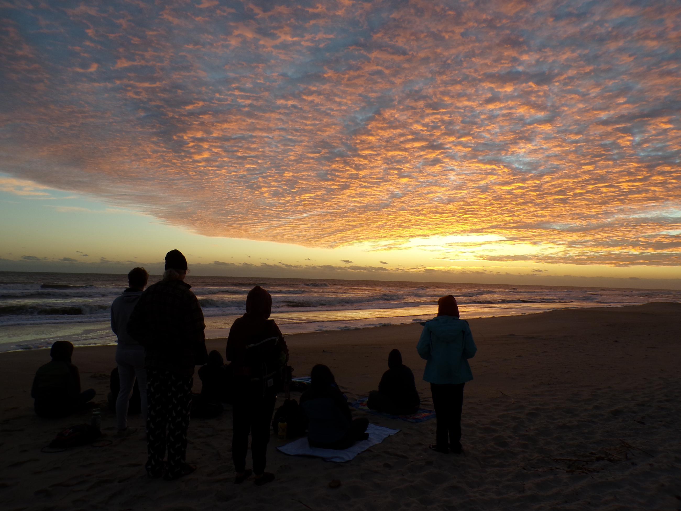 Students on the beach on sunrise