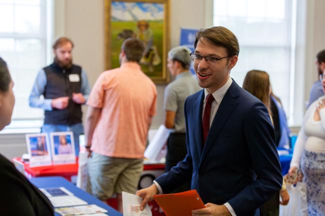 Student interacts with employers at the Business and Communication Career Fair at WU