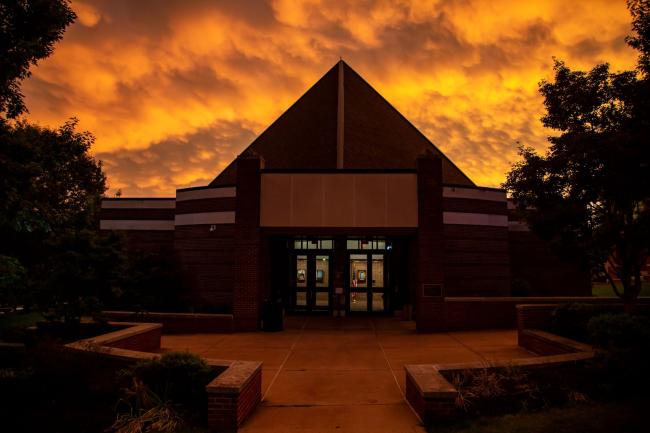 GPAC with an orange summer sunset behind it